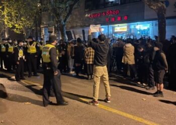 Police barricade street in Shanghai after two nights of protests