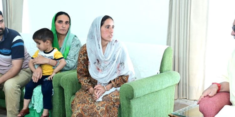 LG meets family of ATM guard shot dead by militants